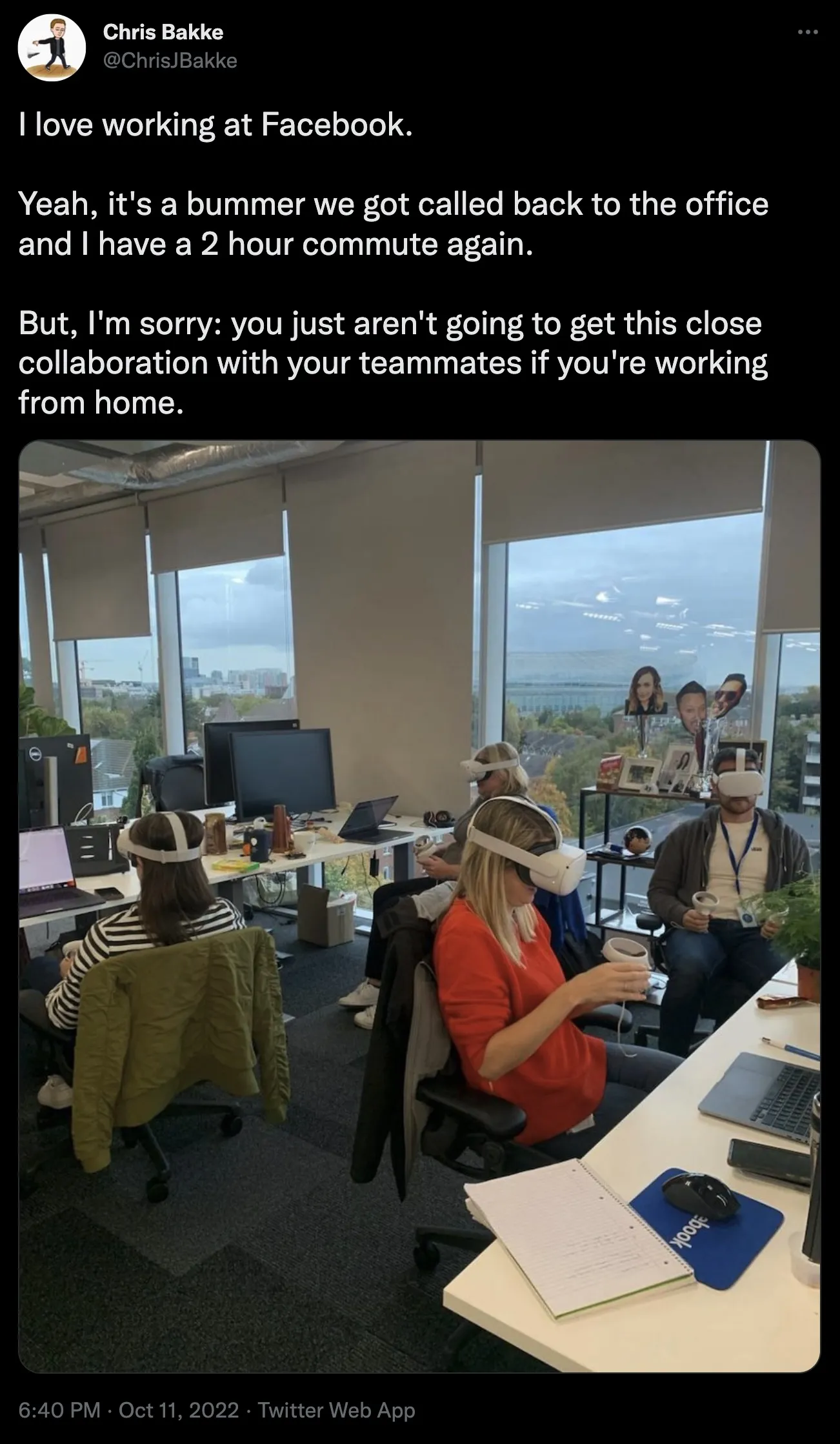 Tweet about working at Facebook with employees at work wearing VR headsets while sitting next to each other