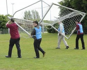 People moving a goalpost