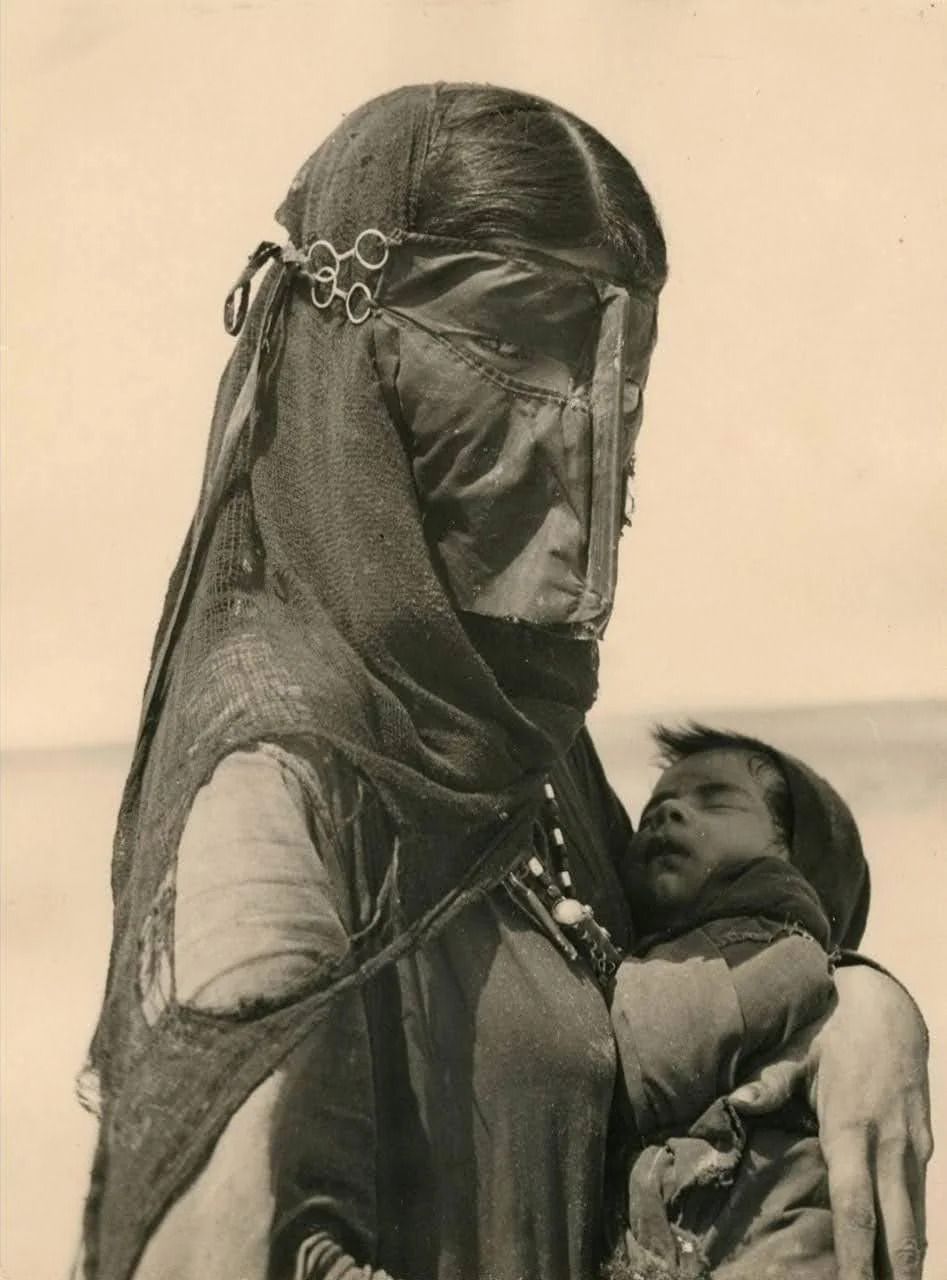 A photo of a bedouin woman and her baby by Ilo Battigelli